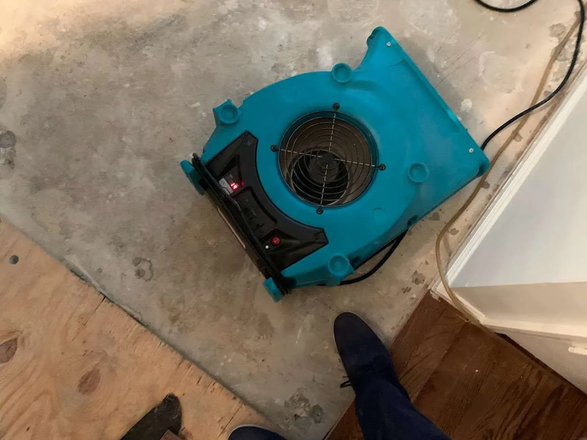 Air mover drying subfloor during Commercial Water Damage Restoration in Plainsboro